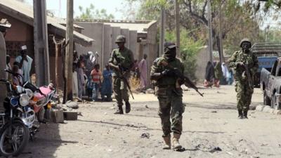 Nigerian troops patrol northeast town of Baga on 30 April 2013.