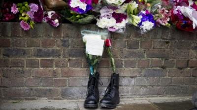 Combat boots containing floral tributes to Drummer Lee Rigby