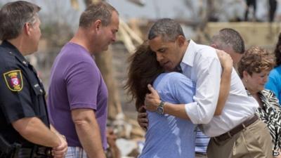 President Barack Obama embraces an official from the devastated Plaza Towers Elementary School