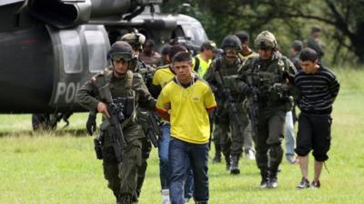 Alleged rebels from Revolutionary Armed Forces of Colombia, or FARC, are escorted by Colombian Police agents in Cali, Colombia,