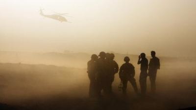 British soldiers silhouetted during training in Helmand. Oct 2009.