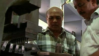 Ajay Modi, left, in his car components factory