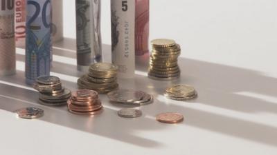 British and European bank notes and coins stacked