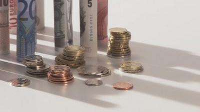 British and European bank notes and coins stacked