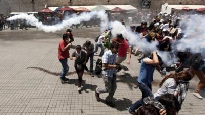 Riot police use tear gas to disperse the crowd during an anti-government protest at Taksim Square