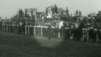 Still from British Pathe footage showing Emily Wilding Davison running onto the course at Epsom