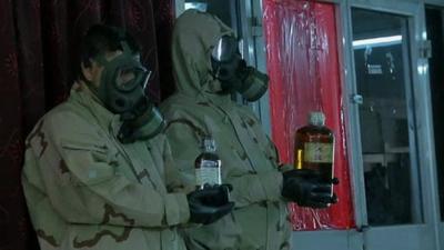 Two Iraqi soldiers hold what is claimed to be chemical weapons