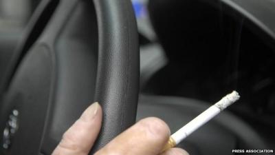 Smoking a cigarette in a car