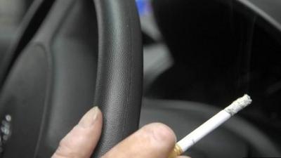 Smoking a cigarette in a car