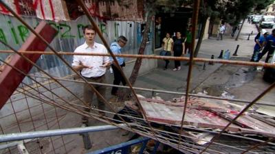 The BBC's James Reynolds as seen through the barricades