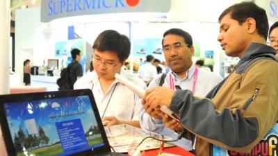 Foreign visitors inspect Chinese products on display at Computex in Taipei