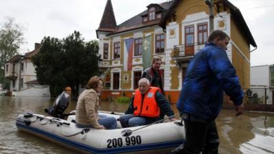 Rescue workers attend to residents of the flooded village of Kresice near the city of Litomerice, June 4, 2013
