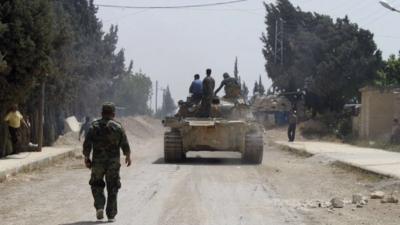 Forces of Syrian President Bashar al-Assad are seen in Qusair village May 30