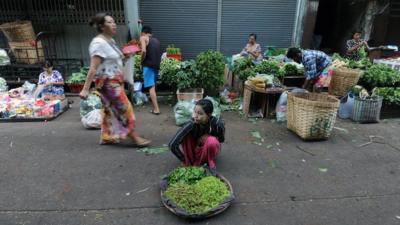 A Burmese vendor sells vegetables at a market in Rangoon