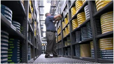 A man storing film canisters in the Academy Film Archive