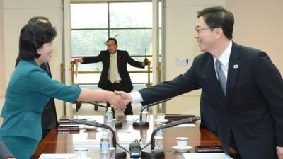 Delegates from North and South Korea shake hands in Panmunjom