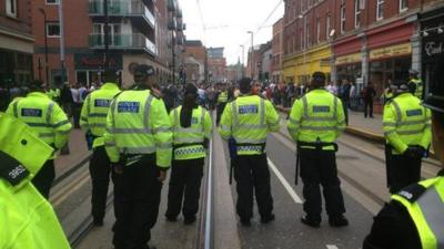 Line of police and protestors