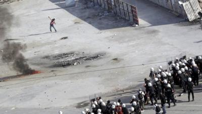 A protester throws a petrol bomb as Turkish riot police fire water cannon and teargas during a protest at Taksim Square in Istanbul June 11, 2013