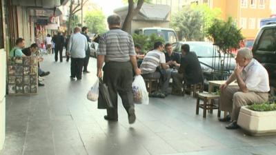 People sit in street in Istanbul