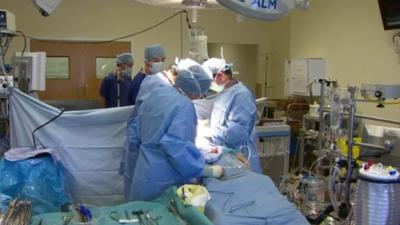 Surgeons carrying out an operation