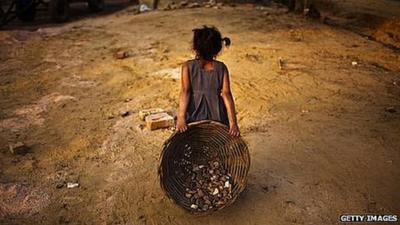 An Indian child working on a construction project