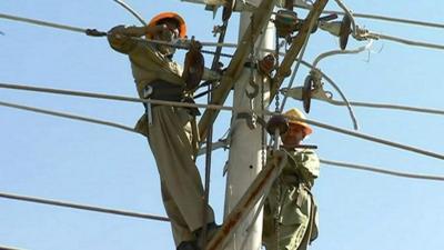 Workers on an electricity pylon in Pakistan