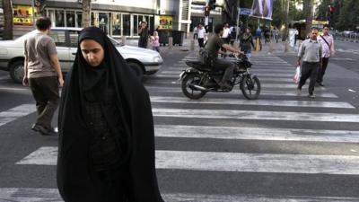 Woman crossing street in Iran