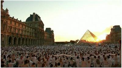 Thousands gather at the Louvre Museum's courtyard.