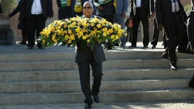 South African President Jacob Zuma lays a floral tribute at the Hector Pieterson memorial