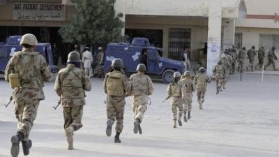 Pakistani paramilitary soldiers take position after militants attacked a hospital in Quetta