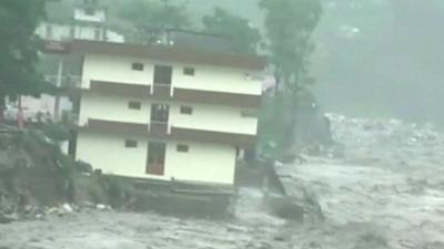 Apartment building surrounded by flood water in Uttarkashi in Uttarakhand state