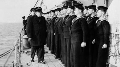 Prime Minister Winston Churchill inspects H.M.S. Scylla in 1942, during the recent Russian convoy operations