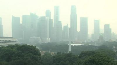 Wood-smoke cloud hangs over Singapore