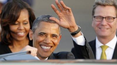 US President Obama waves after arriving in Berlin