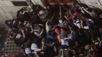 Students try to break down a door of the City Hall building in Sao Paulo, Brazil on June 18, 2013,