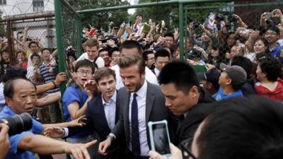 Crowds surround David Beckham