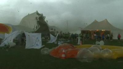 Tent being lifted from the ground by strong winds