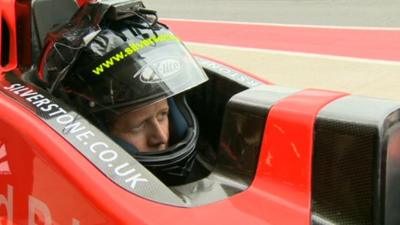 Mike Bushell in the rear seat of a two-seater F1 car