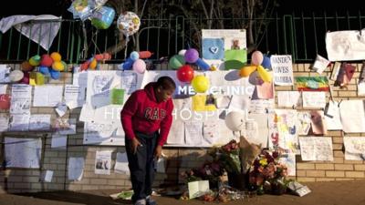 Messages and flowers left outside the hospital where Nelson Mandela is being treated