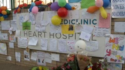 Messages and flowers left at the Pretoria hospital where Nelson Mandela is being treated