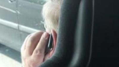 Shearings has suspended the driver pictured on his mobile phone while driving on the M6.