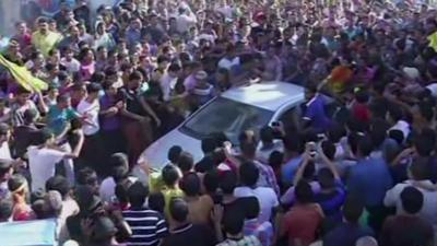 Thousands of fans surround a car carrying Arab Idol winner Mohammed Assaf