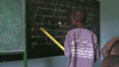 Child at a blackboard at a US-funded school in Senegal