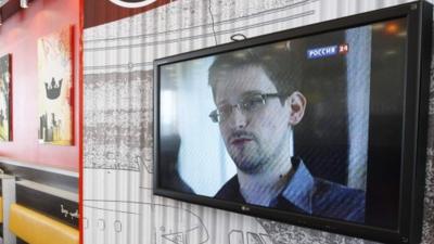 A TV screen shows Edward Snowden during a news bulletin at a cafe at Moscow's Sheremetyevo Airport