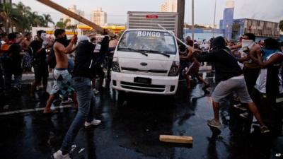 Protesters destroy a van during a demonstration in Belo Horizonte, Brazil