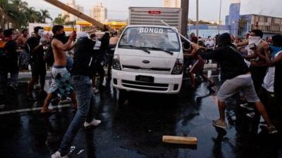 Protesters destroy a van during a demonstration in Belo Horizonte, Brazil