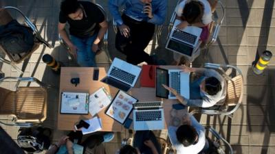 People at a table with laptops