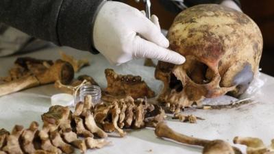 An archaeologist measures the remains of a women believed to be a member of the royalty of the Wari empire. Photo: 27 June 2013