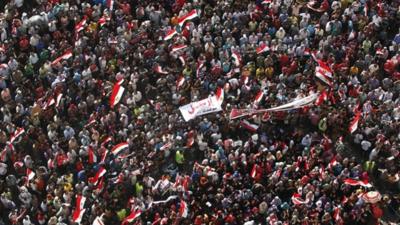 Anti-Mursi protesters carry a banner saying "leave"