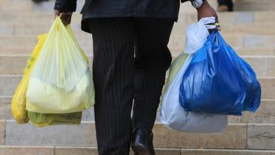 Man carrying plastic bags